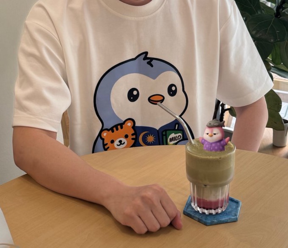 Pengu Malaysia tee — cream tee with Pengu, Malayan tiger and Milo graphic